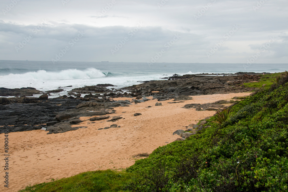 Sandy Beach Covered in Footprints Just off the Shoreline