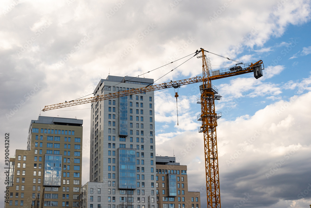 tower construction crane is building a house with office premises in a respectable business class area against the backdrop of skyscrapers of business centers tower construction crane is building a house with office premises in a respectable business class area against the backdrop of skyscrapers of business centers