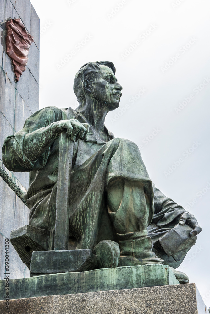 Fragment of the monument to Lenin depicting a revolutionary worker with a hammer during the Great October Socialist Revolution in Russia, created in 1957