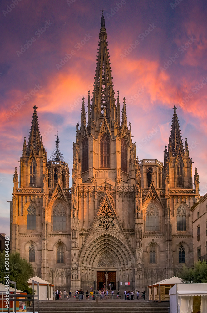 Famous Gothic Cathedral of the Holy Cross and Saint Eulalia or Barcelona Cathedral, seat of the Archbishop of Barcelona, Spain with tourists at sunset