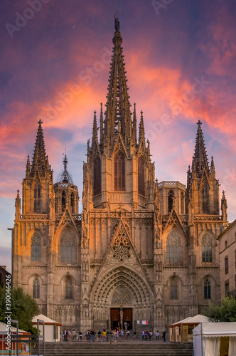 Famous Gothic Cathedral of the Holy Cross and Saint Eulalia or Barcelona Cathedral, seat of the Archbishop of Barcelona, Spain with tourists at sunset