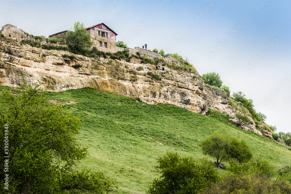 Medieval building on a high cliff above the mountain valley in the famous ancient city-fortress of Chufut-Kale (