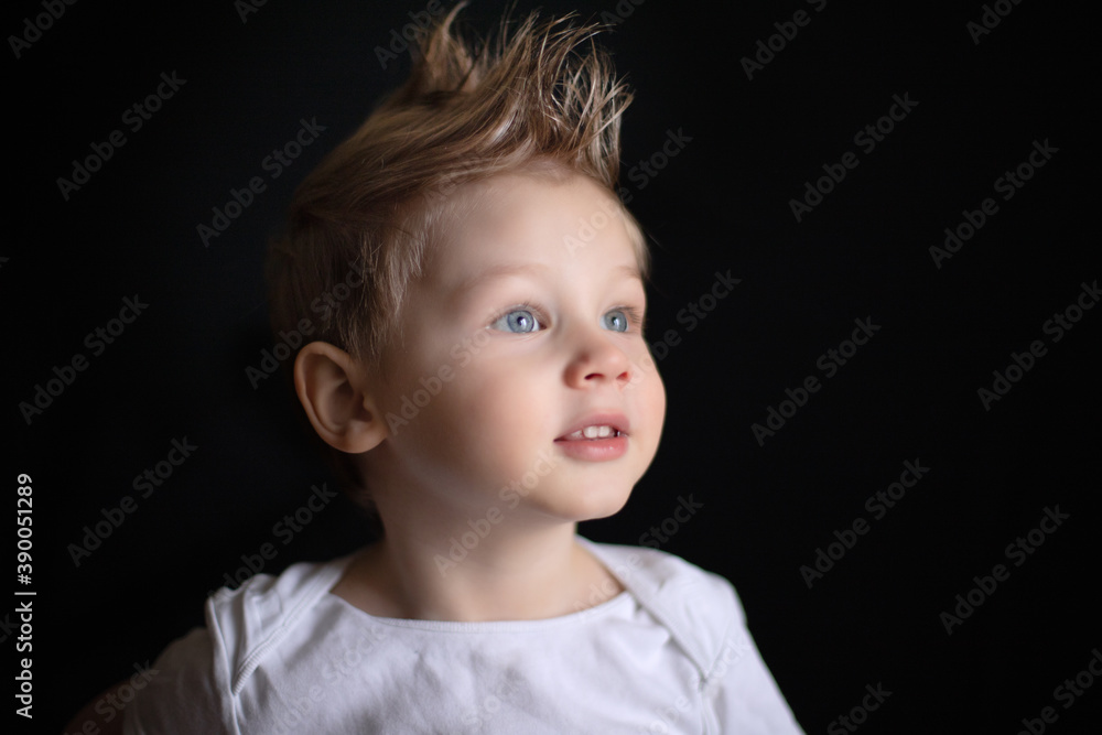 portrait of a boy on a black background portrait of a boy on a black background