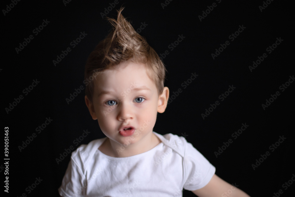 portrait of a boy on a black background portrait of a boy on a black background