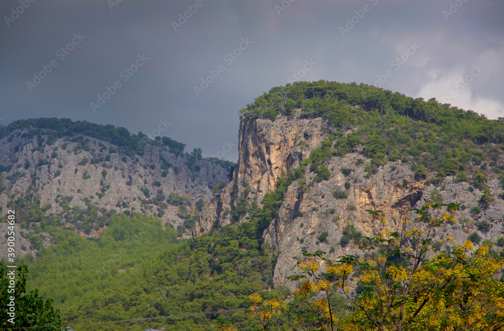 Mountain landscape. The top of the cliff against the background of thunderclouds in the Turkey city of Beldebi.