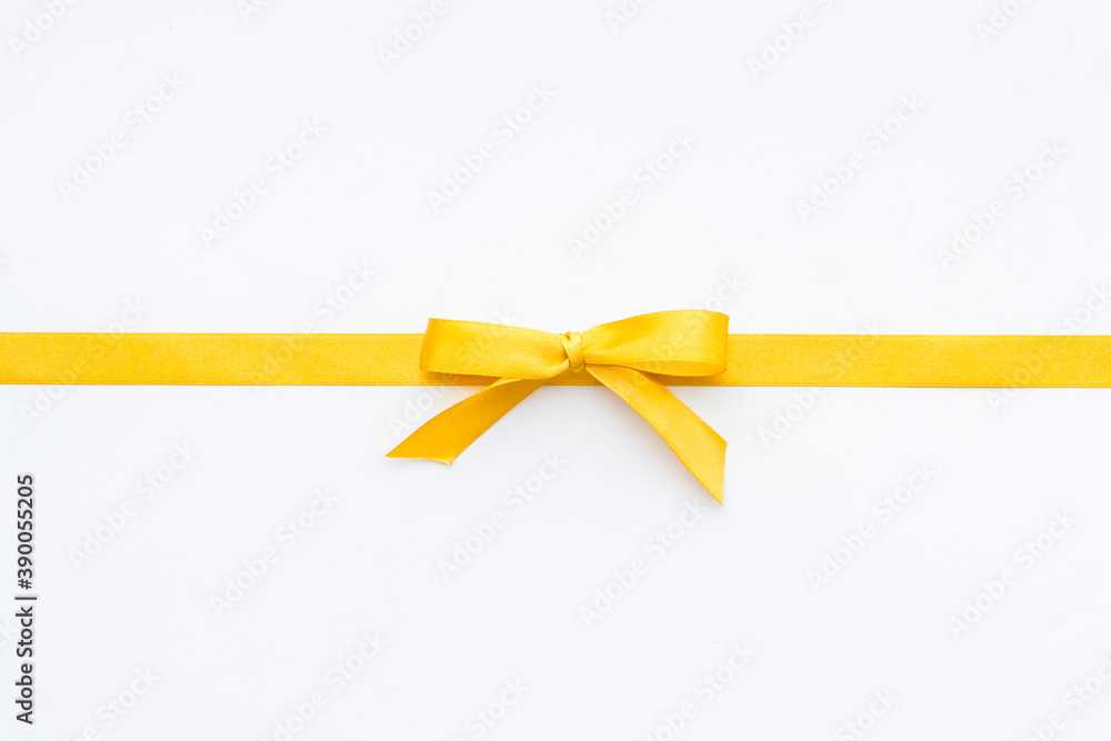 Yellow ribbon bow isolated on white background, top view, copy space Yellow ribbon bow isolated on white background, top view, copy space