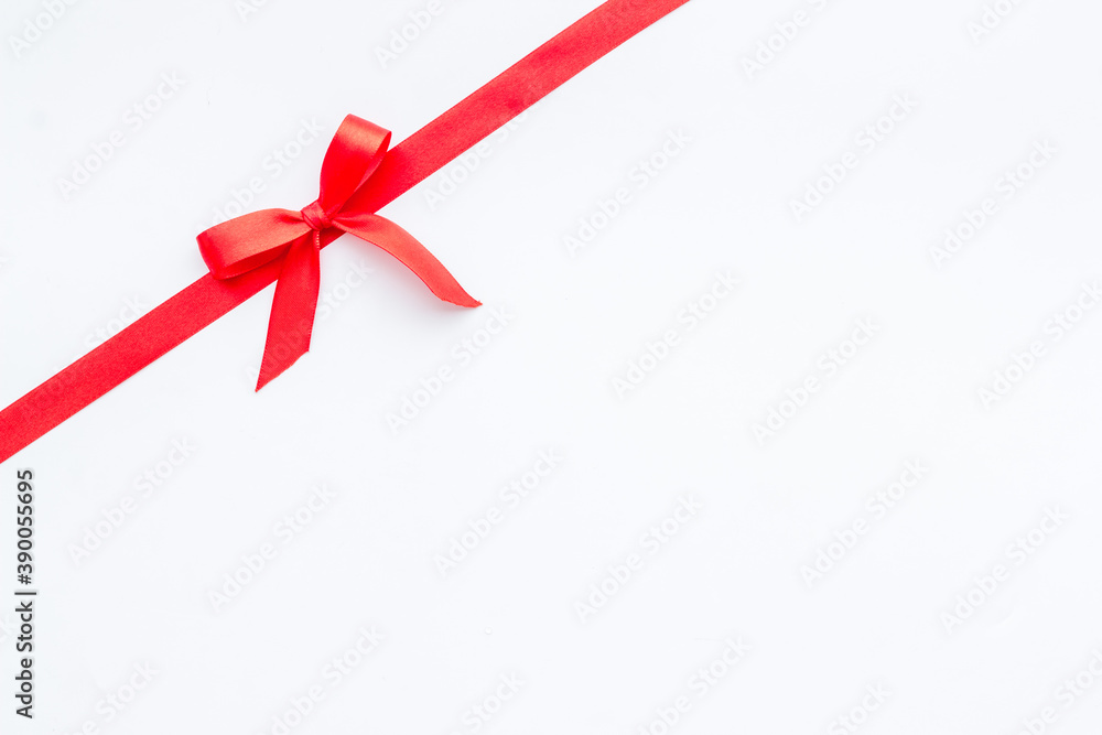 Red ribbon bow on white background, top view, copy space Red ribbon bow on white background, top view, copy space
