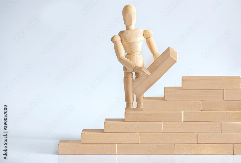 Wooden Man's hand stacking wooden blocks. Business development concept. Wooden Man's hand stacking wooden blocks. Business development concept.