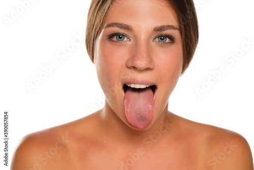 Photo young beautiful woman sticking out her tongue