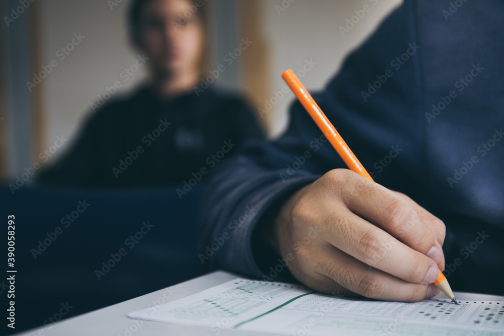 high school,university student study.hands holding pencil writing paper answer sheet.sitting lecture chair taking final exam attending in examination classroom.concept scholarship for education abroad high school,university student study.hands holding pencil writing paper answer sheet.sitting lecture chair taking final exam attending in examination classroom.concept scholarship for education abroad