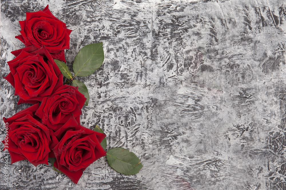 beautiful concrete background decorated with red roses