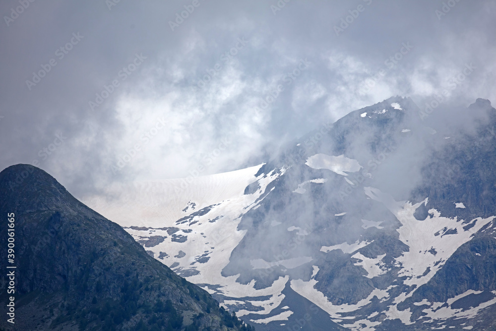 Scenic view of clouds moving over majestic mountains Scenic view of clouds moving over majestic mountains