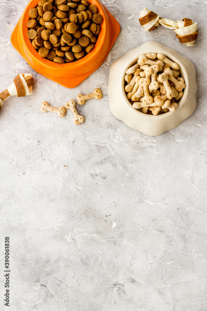 Dry dog food in bowls with bones, top view, copy space Dry dog food in bowls with bones, top view, copy space