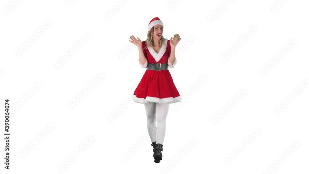 Excited cheerful girl in Santa Christmas costume walks and greet waving hand at camera. Full length isolated on white background. Excited cheerful girl in Santa Christmas costume walks and greet waving hand at camera. Full length isolated on white background.
