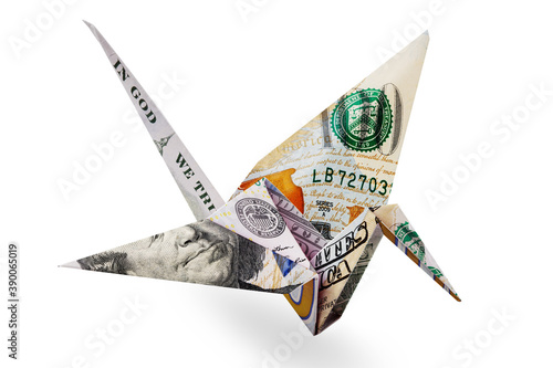 Origami crane made of one hundred dollar bill. Origami crane made of money. Concept represents  money's ability to just fly away. Isolate on white background. Close-up. Side view