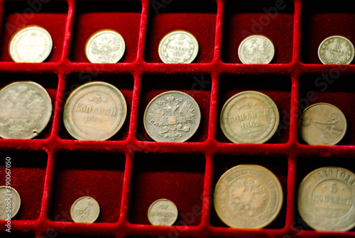 Collection of coins on  red velvet background. Money. Old antique coins from  time of tsarist Russia. photo