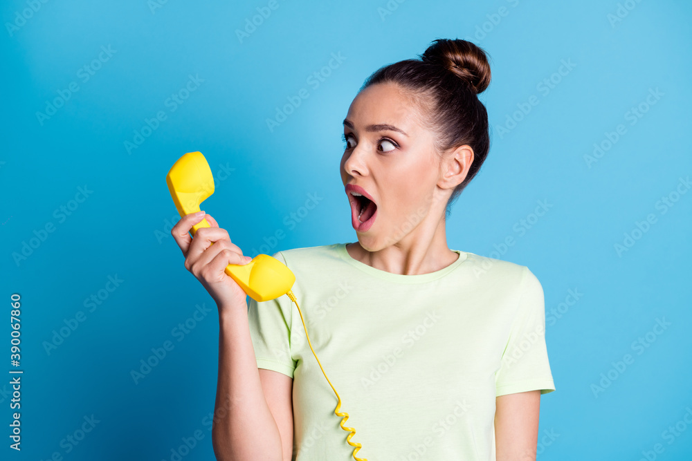 Close-up portrait of her she nice attractive charming lovely worried fury irritated annoyed brown-haired girl talking on yellow phone isolated bright vivid shine vibrant blue color background Close-up portrait of her she nice attractive charming lovely worried fury irritated annoyed brown-haired girl talking on yellow phone isolated bright vivid shine vibrant blue color background