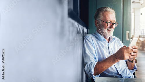 Elderly man watching online movie from his phone