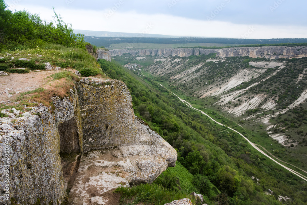 House built in a cave on a high cliff above the mountain valley in the famous ancient city-fortress of Chufut-Kale ( House built in a cave on a high cliff above the mountain valley in the famous ancient city-fortress of Chufut-Kale (