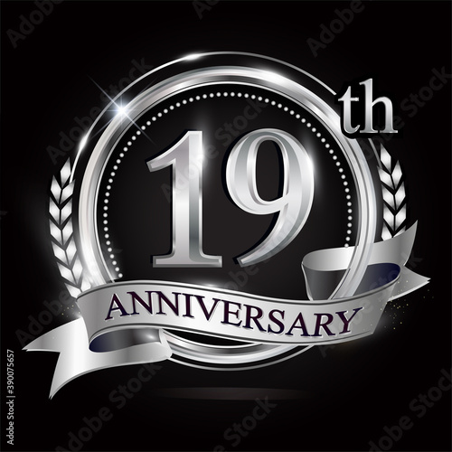 Celebrating 19th anniversary logo, with silver ring and ribbon.