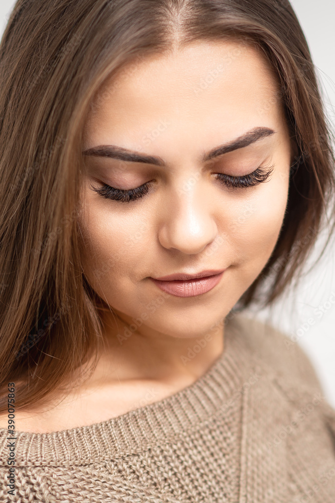 Portrait of beautiful young caucasian woman with closed eyes after eyelash extension procedure and permanent makeup Portrait of beautiful young caucasian woman with closed eyes after eyelash extension procedure and permanent makeup