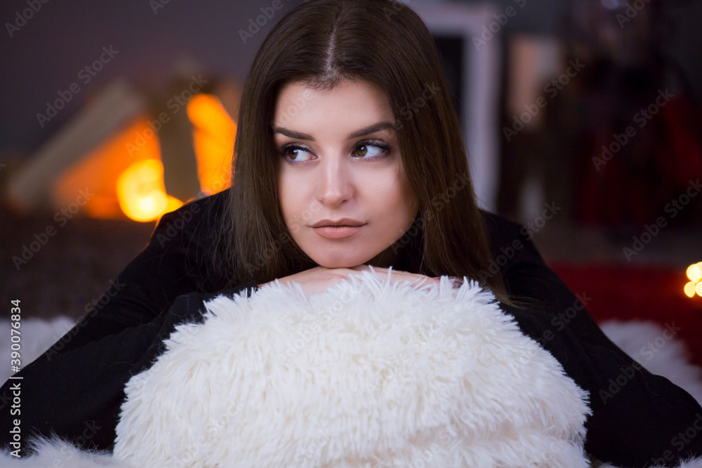 woman cozy portrait fire place in the background woman cozy portrait fire place in the background