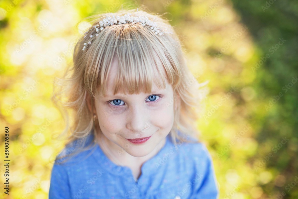 Portrait of a cute blue-eyed girl in a blue shirt Portrait of a cute blue-eyed girl in a blue shirt
