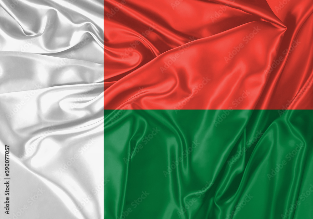 Madagascar flag waving in the wind. National flag on satin cloth surface texture. Background for international concept.