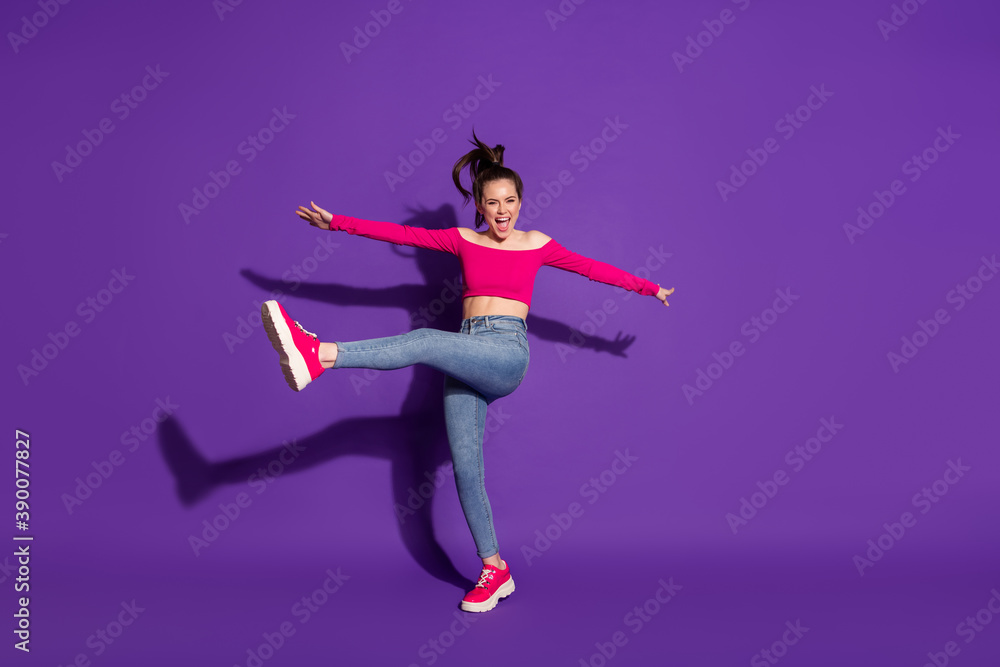 Full length body size view of attractive overjoyed cheerful girl jumping dancing having fun isolated bright violet lilac background Full length body size view of attractive overjoyed cheerful girl jumping dancing having fun isolated bright violet lilac background