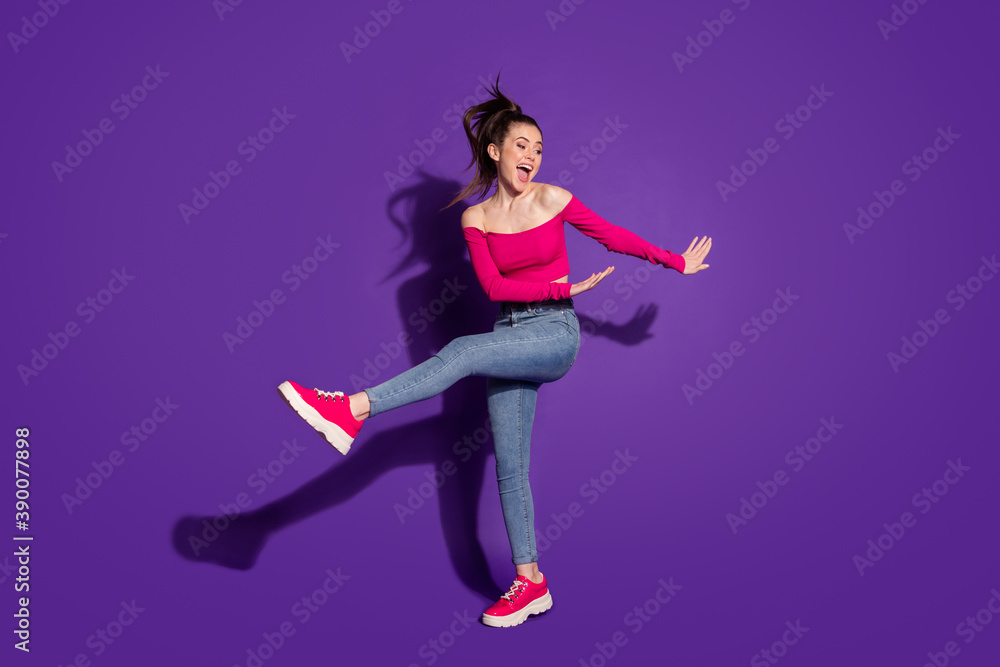 Full length body size view of pretty carefree cheerful girl dancing having fun isolated over bright violet color background