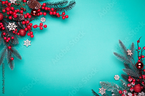 Decorated Christmas tree on the blue background. Top view with copy space for your text.