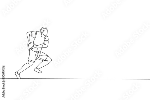 One continuous line drawing of young rugby player catch and defend the ball. Competitive aggressive sport concept. Dynamic single line draw design vector illustration for tournament promotion media