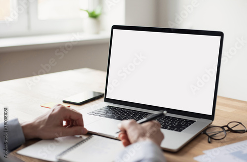 Man professional working in office, businessman using laptop computer with blank empty screen, work or studying from home, freelance, online learning, distance education concept