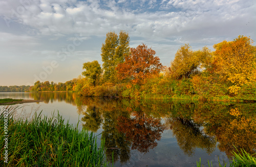 The lake is surrounded by beautiful autumn trees.