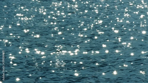 Slow motion of blue sea water surface with sparks