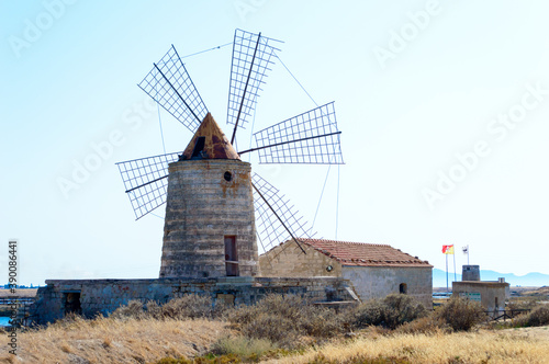 One of the many wind mill of the Trapani's salt pans with its characteristic red roof 