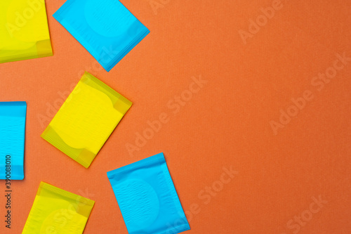 Woman hygienic pads on orange background top view