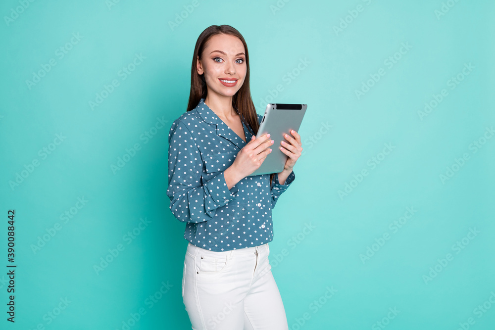 Photo of positive cheerful secretary lady hold tablet isolated over teal color background Photo of positive cheerful secretary lady hold tablet isolated over teal color background