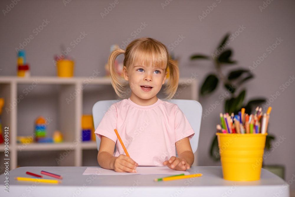 Cute little child girl writing with pencils in day care center Cute little child girl writing with pencils in day care center