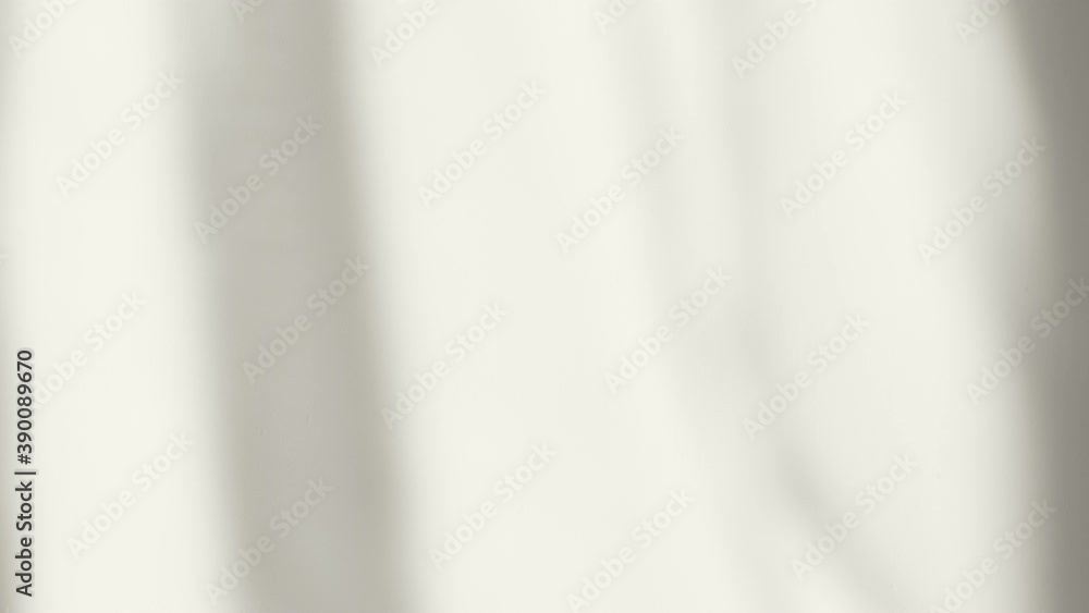 The light from the window on the wall, the transparent shadow from the curtain is moving, blurry moving shadows on the wall. Morning sun light in room, background overlay.