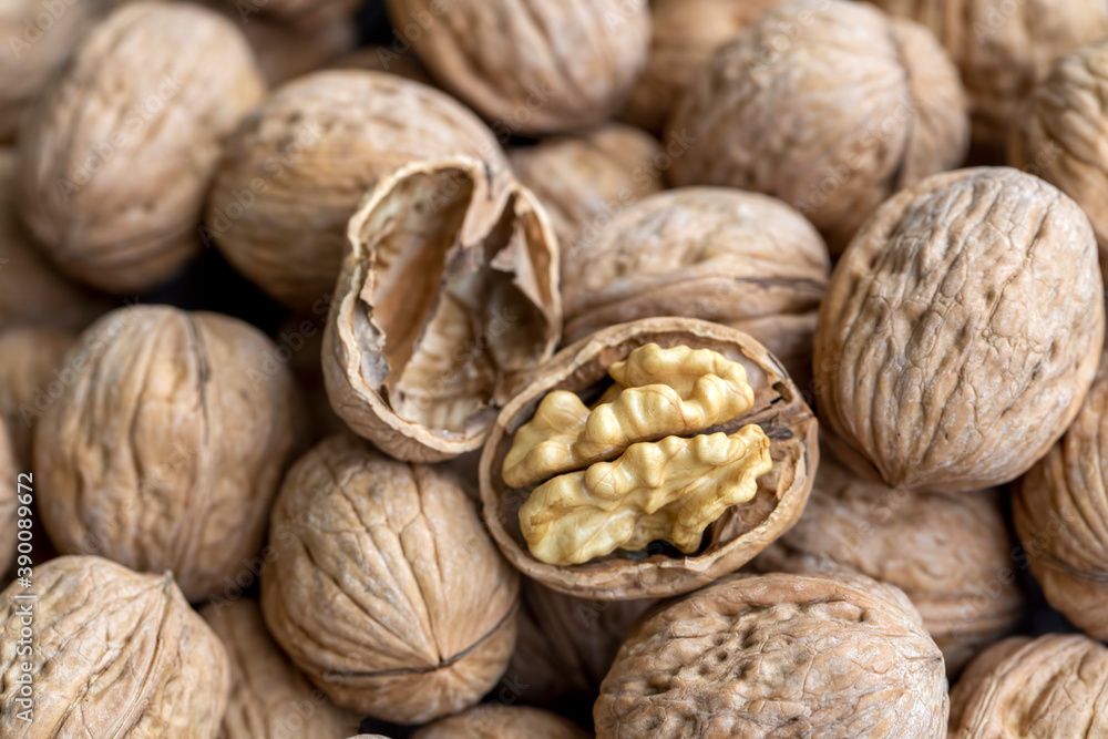 Ripe and raw whole big walnut kernel with thin shell on wooden rustic backdrop. Healthy nut food for brain. Fresh walnuts background concept Ripe and raw whole big walnut kernel with thin shell on wooden rustic backdrop. Healthy nut food for brain. Fresh walnuts background concept