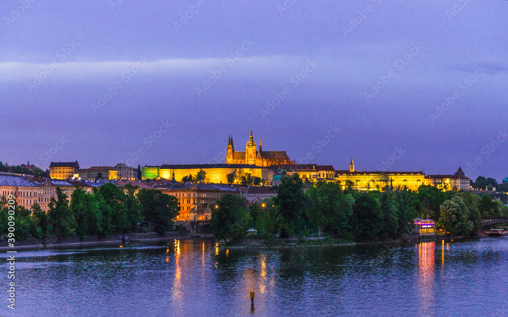 View of Prague old town, historical center with Prague Castle, St. Vitus Cathedral in Hradcany district, Vltava river, night evening twilight view, Bohemia, Czech Republic
