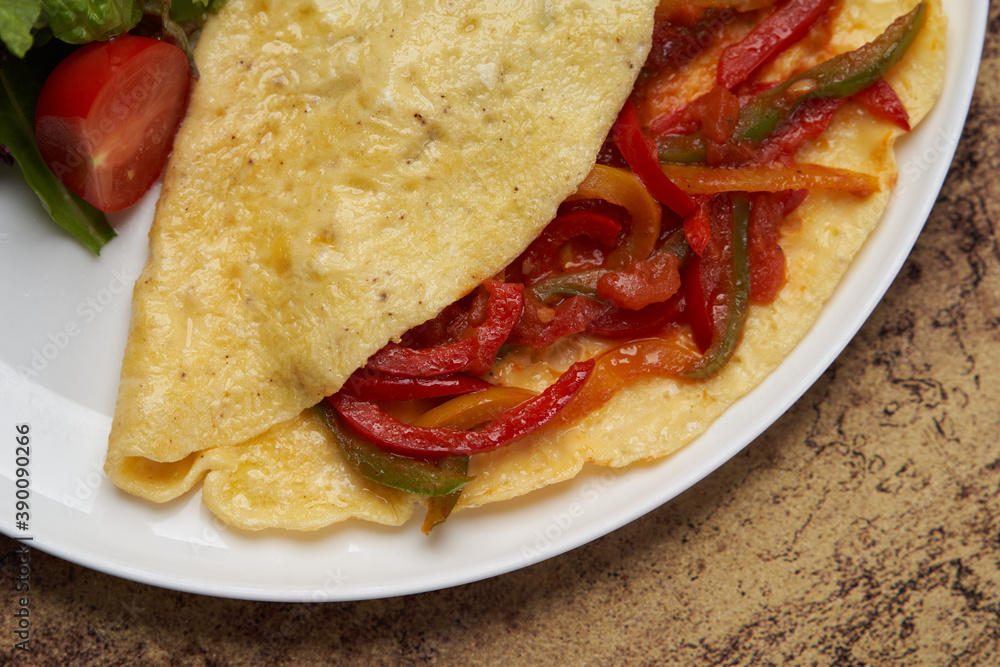 Omelette with vegetables on wooden background Omelette with vegetables on wooden background