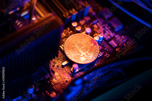 Bitcoin Cryptocurrency coin on a PC computer motherboard, crypto currency mining concept.
