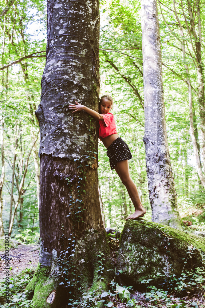 Connecting With Nature. Little girl embracing tree in the woods. Love Nature Concept Connecting With Nature. Little girl embracing tree in the woods. Love Nature Concept