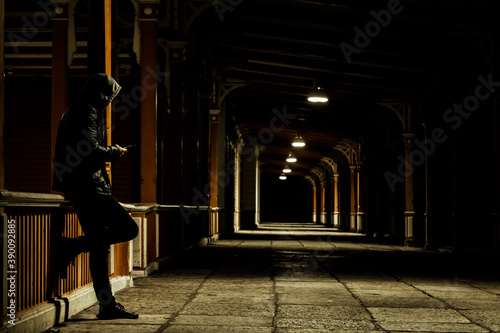 lonely man with smartphone in the night