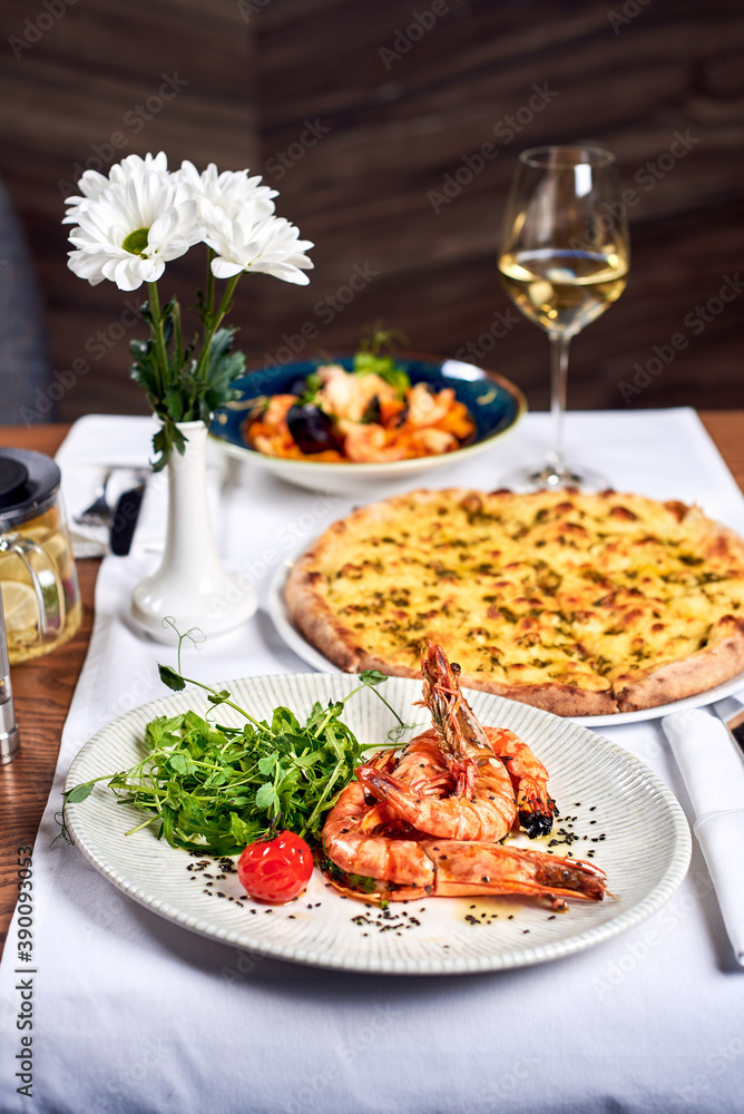 Fried shrimps and pizza on a table