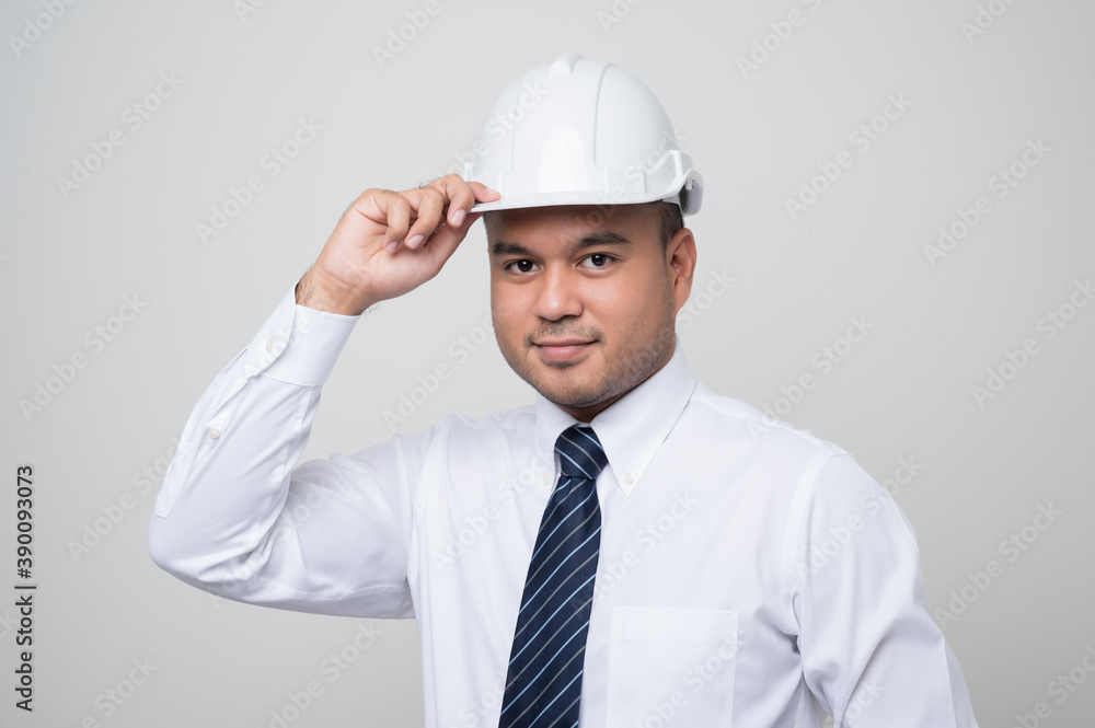 Smiling young handsome asian civil engineer standing on isolated white background. Manager senior mechanic in studio. Smiling young handsome asian civil engineer standing on isolated white background. Manager senior mechanic in studio.