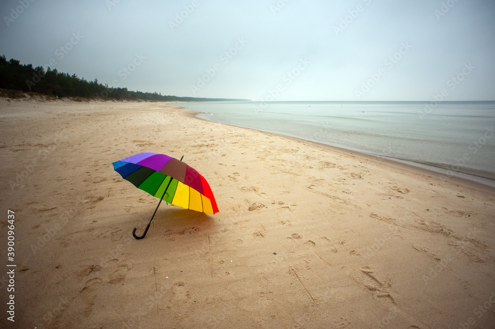 Rainbow umbrella on the beach