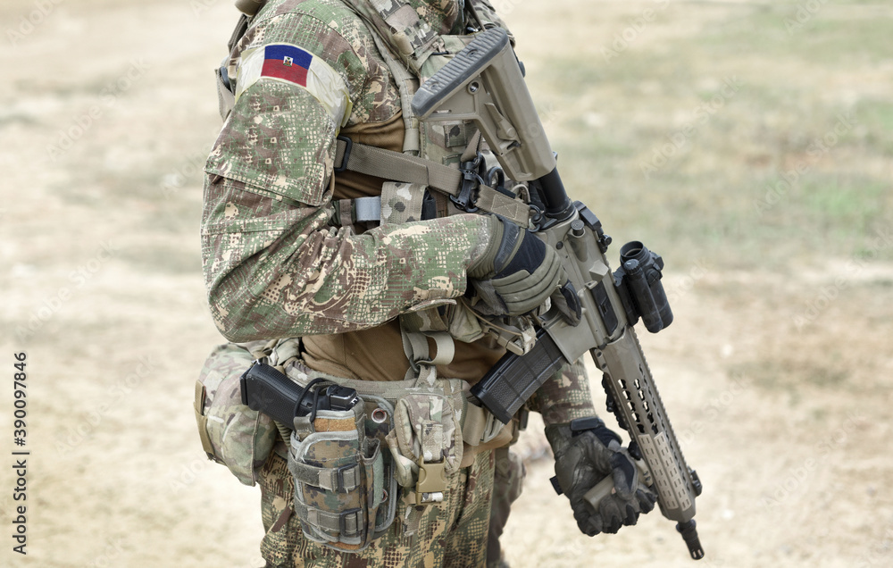 Soldier with assault rifle and flag of Haiti on military uniform. Collage.